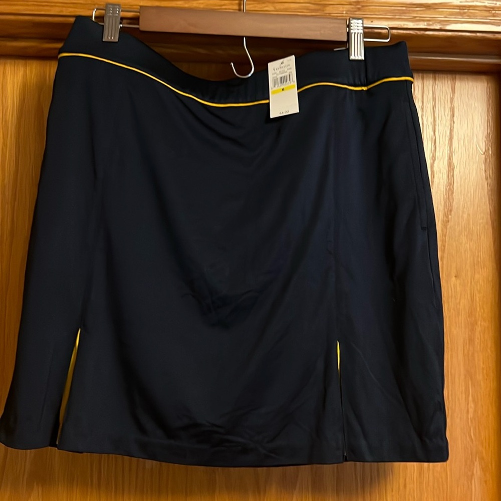New fun golf skort with tags.  Navy blue with yellow piping. Light weight.